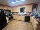 Kitchen featuring wood cabinetry and stainless steel appliances at 11234 Areca Dr, Port Richey, FL 34668