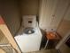 Laundry room featuring a white washing machine and shelving storage at 11234 Areca Dr, Port Richey, FL 34668