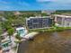 Aerial view showcasing the condo building, swimming pool, and waterfront location at 1510 1St W Ave # 102, Bradenton, FL 34205