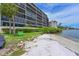 Sandy beach with a bench near the waterfront condos at 1510 1St W Ave # 102, Bradenton, FL 34205