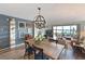 Bright dining room with water views, hardwood floors, and unique light fixture at 1510 1St W Ave # 102, Bradenton, FL 34205