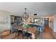 Open kitchen and dining room area with hardwood floors and modern lighting fixtures at 1510 1St W Ave # 102, Bradenton, FL 34205