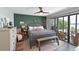 Comfortable main bedroom featuring a large bed, wood floors and outdoor access at 1510 1St W Ave # 102, Bradenton, FL 34205