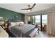 Cozy main bedroom featuring a stylish ceiling fan and access to an outdoor patio at 1510 1St W Ave # 102, Bradenton, FL 34205