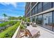 Large patio with marina views, seating, landscaping, and direct access to the living space at 1510 1St W Ave # 102, Bradenton, FL 34205
