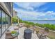 Spacious patio with lounging chairs, greenery, and breathtaking water views at 1510 1St W Ave # 102, Bradenton, FL 34205