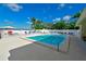 Sparkling waterfront pool with palm trees and ample lounge space at 1510 1St W Ave # 102, Bradenton, FL 34205