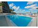 Inviting waterfront pool area with lounge chairs and bay views at 1510 1St W Ave # 102, Bradenton, FL 34205