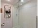 Modern walk-in shower with white subway tile, glass door, and stylish fixtures at 1510 1St W Ave # 102, Bradenton, FL 34205