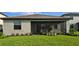 Backyard view of house and screen patio area, landscaping included at 15115 Oxford Grey Dr, Bradenton, FL 34211