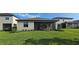 Backyard view of house and screen patio area, landscaping included at 15115 Oxford Grey Dr, Bradenton, FL 34211