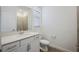 Bathroom features a large vanity, mirror, toilet, and walk-in shower at 15115 Oxford Grey Dr, Bradenton, FL 34211