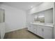 Bathroom with double sink vanity, a large mirror, and tiled shower at 15115 Oxford Grey Dr, Bradenton, FL 34211
