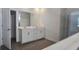 Bright bathroom featuring double sinks, white cabinetry, and a large mirror at 15115 Oxford Grey Dr, Bradenton, FL 34211