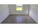 Empty bedroom with wood-look tiling and window at 15115 Oxford Grey Dr, Bradenton, FL 34211