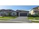 Attractive single-Gathering house with a well-kept lawn and gray two-car garage at 15115 Oxford Grey Dr, Bradenton, FL 34211