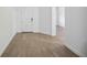 Bright foyer featuring wood-look floors, white walls, and entry to other rooms at 15115 Oxford Grey Dr, Bradenton, FL 34211