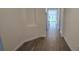 Clean hallway featuring stylish wood-look tile flooring, light walls, and a bright view at 15115 Oxford Grey Dr, Bradenton, FL 34211