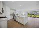 Open kitchen with a center island, stainless appliances, and an adjacent sunroom at 15115 Oxford Grey Dr, Bradenton, FL 34211