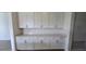 Kitchen nook showcasing white cabinets and countertop space, perfect for storage at 15115 Oxford Grey Dr, Bradenton, FL 34211