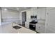 Modern kitchen with white cabinets, stainless steel appliances, and a gas range at 15115 Oxford Grey Dr, Bradenton, FL 34211