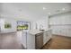 Open kitchen with a center island, stainless appliances, and lots of natural light at 15115 Oxford Grey Dr, Bradenton, FL 34211