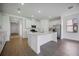 Spacious kitchen with stainless appliances, white cabinets, an island, and quartz counters at 15115 Oxford Grey Dr, Bradenton, FL 34211
