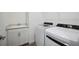 Laundry room features a sink with white cabinets, washer, and dryer at 15115 Oxford Grey Dr, Bradenton, FL 34211