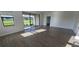 Bright living room featuring wood-look flooring and sliding glass doors to the outdoors at 15115 Oxford Grey Dr, Bradenton, FL 34211