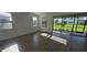 Bright living room featuring wood-look flooring and sliding glass doors to the outdoors at 15115 Oxford Grey Dr, Bradenton, FL 34211