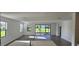 Open-concept living room featuring wood-look floors and sliding glass doors to the outdoors at 15115 Oxford Grey Dr, Bradenton, FL 34211