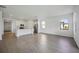 Spacious living area features wood-look tile flooring, open to the modern kitchen at 15115 Oxford Grey Dr, Bradenton, FL 34211