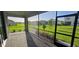 Screened patio with brick flooring overlooking green backyard and neighborhood at 15115 Oxford Grey Dr, Bradenton, FL 34211