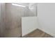 Modern bathroom features a glass shower with neutral tile and a small window for natural light at 15115 Oxford Grey Dr, Bradenton, FL 34211