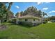 Expansive backyard with mature trees and views of the house, a delightful outdoor space at 1674 Cottonwood Trl, Sarasota, FL 34232