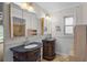 Elegant bathroom showcasing dual dark wood vanities with granite countertops and stylish fixtures at 1674 Cottonwood Trl, Sarasota, FL 34232