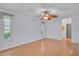 Spacious bedroom with light blue paint, ceiling fan, wood floors, and trim at 1674 Cottonwood Trl, Sarasota, FL 34232