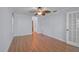 Bedroom with wood floors, natural paint, ceiling fan and white door at 1674 Cottonwood Trl, Sarasota, FL 34232
