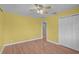 Bright bedroom featuring hardwood floors, natural light, closet and an open door at 1674 Cottonwood Trl, Sarasota, FL 34232