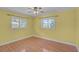 Bedroom featuring hardwood floors, natural light, and two windows at 1674 Cottonwood Trl, Sarasota, FL 34232