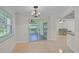 Bright dining room featuring tile floors, backyard access, and a modern chandelier at 1674 Cottonwood Trl, Sarasota, FL 34232