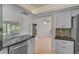 Bright eat-in kitchen with granite countertops, stainless appliances, and modern white cabinets at 1674 Cottonwood Trl, Sarasota, FL 34232