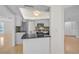 Eat-in kitchen with granite countertops, stainless appliances, mosaic backsplash, and modern white cabinets at 1674 Cottonwood Trl, Sarasota, FL 34232