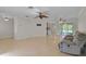 Open-concept living space with tile flooring, neutral paint, ceiling fans, and easy access to the lanai at 1674 Cottonwood Trl, Sarasota, FL 34232