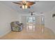 Spacious living room featuring tile flooring and natural light with an armchair at 1674 Cottonwood Trl, Sarasota, FL 34232