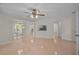 Bright living room featuring tiled floors and a view into adjacent rooms and the kitchen at 1674 Cottonwood Trl, Sarasota, FL 34232