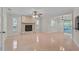 Open living area with stone fireplace and tiled flooring leads to a screened patio at 1674 Cottonwood Trl, Sarasota, FL 34232
