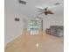 Large living room featuring neutral paint, tile floors, ceiling fans, and a sliding glass door for seamless indoor/outdoor living at 1674 Cottonwood Trl, Sarasota, FL 34232
