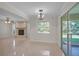 Cozy living room with decorative fireplace, tile flooring, backyard access, and lots of natural light at 1674 Cottonwood Trl, Sarasota, FL 34232