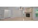 Spacious living room with stone fireplace, tile flooring, backyard access, and lots of natural light at 1674 Cottonwood Trl, Sarasota, FL 34232